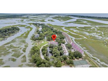 Stunning aerial view of marsh-front townhomes in a desirable waterside community at 202 Mariners Cay Dr, Folly Beach, SC 29439