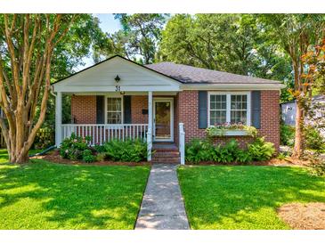 Charming brick home with a manicured lawn and inviting front porch with flower boxes at 31 Lyttleton Ave, Charleston, SC 29407