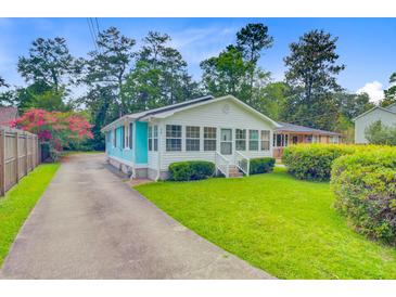 Charming home with a well-manicured lawn, quaint front porch, and inviting curb appeal at 316 Simmons Ave, Summerville, SC 29483
