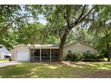 Charming single-story home with a covered porch, lush lawn, and a mature, shade-providing tree at 3347 Walter Drive, Johns Island, SC 29455