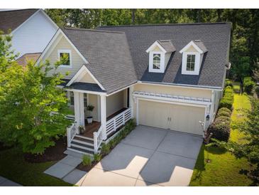 Charming home featuring a welcoming front porch, attached two car garage, and beautifully landscaped yard at 3537 Crosstrees Ln, Mount Pleasant, SC 29466