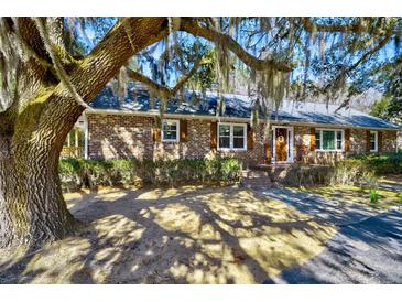 Charming brick home with meticulous landscaping and inviting front entrance at 4715 Highway 165, Meggett, SC 29449