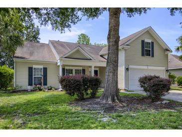 Charming home with mature trees, manicured lawn and window shutters at 5011 W Liberty Meadows Dr, Summerville, SC 29485