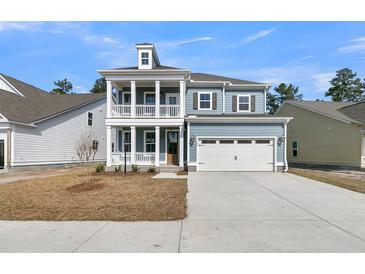 Charming two-story home with a welcoming front porch and a two-car garage, providing ample space and curb appeal at 772 Maynard Ln, Summerville, SC 29486