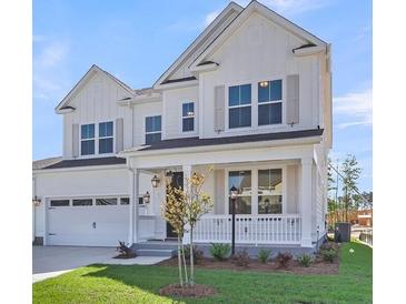 Charming two-story home showcasing a white exterior, front porch, and well-maintained landscaping at 776 Maynard Ln, Summerville, SC 29486