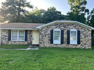 Charming brick home with a yellow front door and black shutters; perfect for curb appeal at 980 Margaret Dr, Ladson, SC 29456