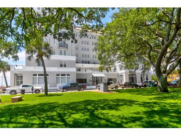 Beautiful multi-story building with lush landscaping and ample parking for residents and guests at 1 King # 702, Charleston, SC 29401