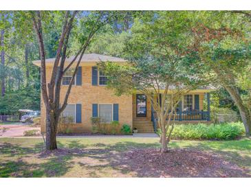 Charming two-story brick home featuring a welcoming front porch and lush landscaping at 105 Greendale Ct, Summerville, SC 29485