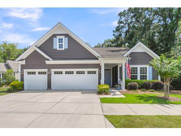 Charming single-story home featuring a two-car garage, well-manicured lawn, and inviting curb appeal at 1115 Old Field Dr, Summerville, SC 29483