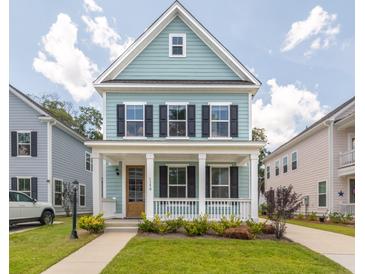 Charming two-story home with a welcoming front porch and well-manicured lawn at 1150 Oak Bluff Ave, Charleston, SC 29492