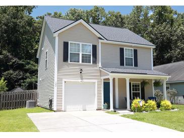 Charming two-story home featuring a welcoming front porch and a one-car garage at 122 Avalon Rd, Summerville, SC 29483