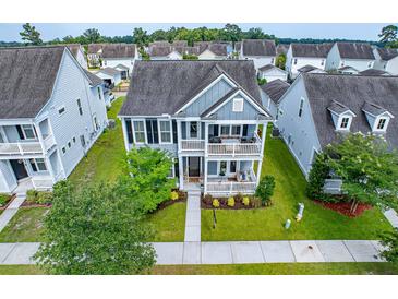 Charming two-story home with a double porch and manicured lawn at 1726 Winfield Way, Charleston, SC 29414