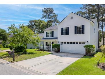 Charming two-story home boasts a manicured front lawn and inviting curb appeal at 207 Breckingridge Dr, Ladson, SC 29456