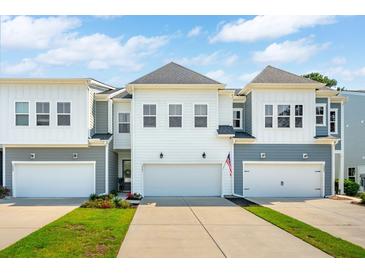 Charming townhomes feature white and gray exteriors, attached garages, and a concrete driveway at 3082 Emma Ln, Mount Pleasant, SC 29466