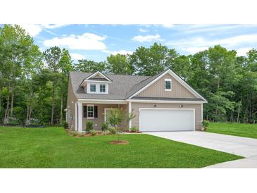 Charming single-Gathering home with a two-car garage, manicured lawn, and mature trees in a desirable neighborhood at 403 Cadbury Loop, Summerville, SC 29486