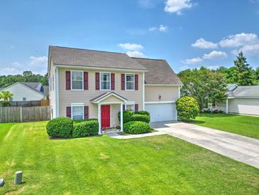 Charming two-story home with a well-manicured lawn, red front door, and attached garage at 412 Beverly Dr, Summerville, SC 29485