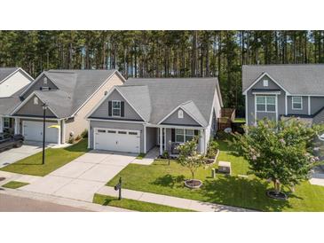 Charming single-Gathering home featuring a manicured lawn and welcoming front porch in a desirable neighborhood at 491 Foxbank Plantation Blvd, Moncks Corner, SC 29461