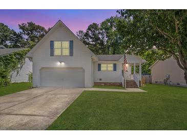 Charming two-story home with a manicured lawn and a two-car garage at 5052 Hidden Forest Ln, North Charleston, SC 29420