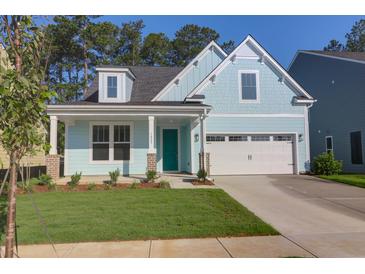 Charming, light blue single-Gathering home with a well-maintained lawn and a bright turquoise front door at 1009 Field Sparrow Dr # Cc3-2-6, Ravenel, SC 29470