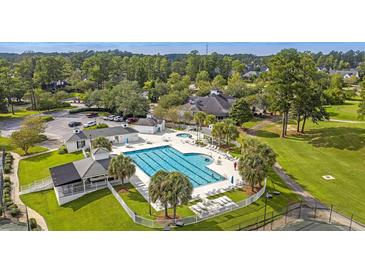 Stunning aerial view of the community pool, with palm trees and plenty of lounge chairs at 112 Riviera Dr, Summerville, SC 29483