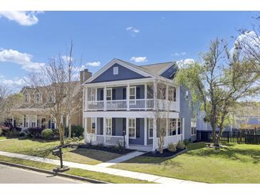 Charming two-story home with a double porch, well-maintained landscaping, and a beautiful blue exterior on a sunny day at 117 Red Leaf Blvd, Moncks Corner, SC 29461