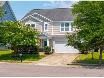 Charming two-story home with a well-maintained lawn, mature trees, and attached two-car garage at 135 Gaslight Blvd, Summerville, SC 29483