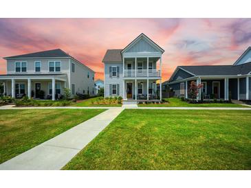 Charming two-story home with a double front porch and manicured lawn at 203 Symphony Ave, Summerville, SC 29486