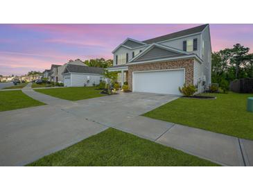 Charming two-story home featuring a two-car garage, brick accents, and a well-manicured lawn in a suburban neighborhood at 225 N Light Way, Summerville, SC 29486