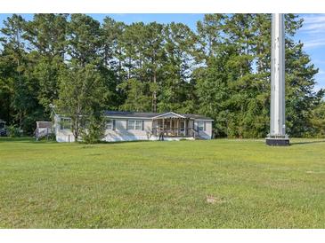 Well maintained single-story home with vinyl siding and a spacious front yard at 250 W Medina St, Summerville, SC 29483