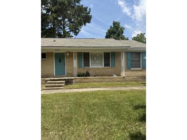 Charming single-story brick home featuring teal shutters, a matching front door, and a well-kept lawn at 3307 Londonderry Rd, North Charleston, SC 29420