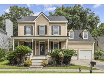 Charming two-story home featuring a welcoming front porch with beautiful landscaping and a two car garage at 3525 E Higgins Dr, Mount Pleasant, SC 29466