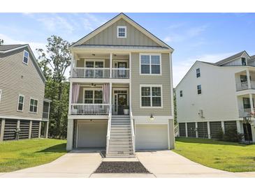 Charming two-story coastal home featuring double balconies, stairs to the entry and well-manicured lawn and landscaping at 3705 Sandy Gate Ln, Mount Pleasant, SC 29466