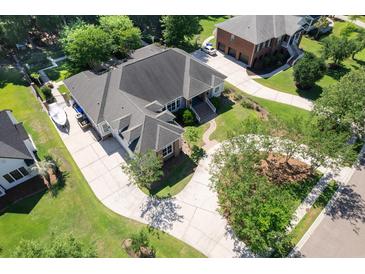 Stunning aerial view of a home with a circular driveway, lush landscaping, and manicured lawns at 3751 St Ellens Dr, Mount Pleasant, SC 29466