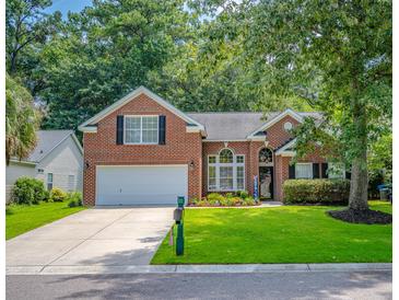 Charming brick home with a well-manicured lawn, two-car garage, and lovely landscaping at 808 Long Drive Rd, Summerville, SC 29485