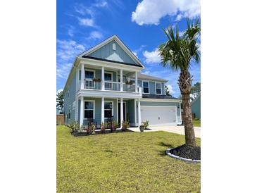 Charming two-story home featuring a spacious porch, rocking chairs, and a well-manicured lawn at 122 Riley Farms Ct, Summerville, SC 29486