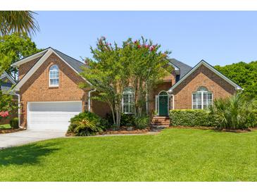 Charming brick home with lush green lawn, mature trees, and a welcoming front entrance at 1441 Waterside Ct, Mount Pleasant, SC 29464