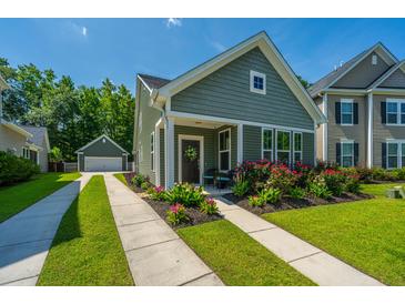 Charming home with a well-manicured lawn, colorful flowerbeds, and a convenient detached garage at 1607 Roustabout Way, Charleston, SC 29414