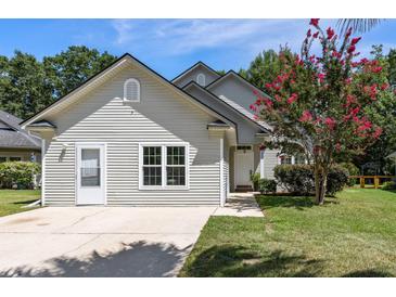 Charming single-story home with light siding, a well-manicured lawn, and a vibrant crape myrtle tree at 2009 Arundel Pl, Mount Pleasant, SC 29464
