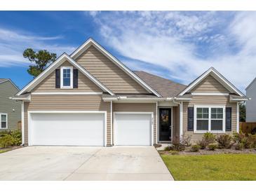 Charming home featuring a two-car garage, neutral siding, and a well-manicured front yard at 2722 Sunrose Ln, Johns Island, SC 29455