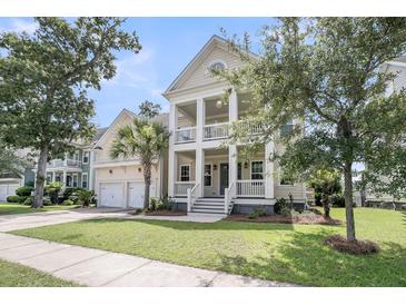Charming two-story home featuring a spacious front yard and double front porches for enjoying the outdoors at 3020 River Vista Way, Mount Pleasant, SC 29466