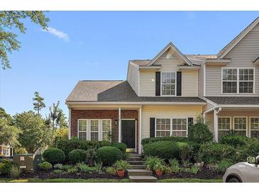 Charming townhome featuring a manicured lawn and inviting front porch at 312 Kelsey Blvd, Wando, SC 29492