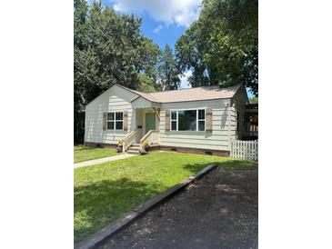 Charming single-story home with light siding, shuttered windows, and well-maintained front yard at 5010 Converse St, North Charleston, SC 29405