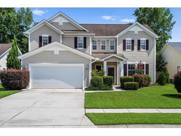 Charming two-story home with a manicured lawn, attached garage, and beautiful landscaping in a suburban neighborhood at 644 Grassy Hill Rd, Summerville, SC 29483