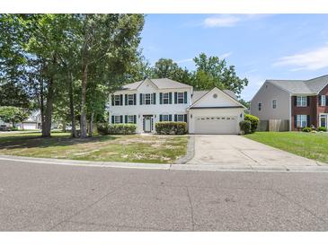 Charming two-story home with green shutters, attached garage, and meticulously manicured front yard at 9253 N Moreto Cir, Summerville, SC 29485