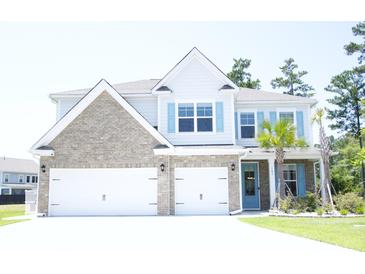 Charming two-story home featuring a brick and siding facade, a three-car garage, and lush landscaping at 103 Granton Edge Ln, Summerville, SC 29486