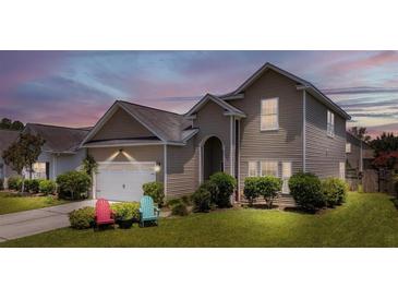 Charming two-story home features a well-maintained lawn, inviting entrance, and attached garage at 112 Worthington Dr, Moncks Corner, SC 29461