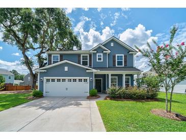 Charming two-story home featuring a well-manicured lawn and a two car garage at 2024 Lanneau Ln, Johns Island, SC 29455