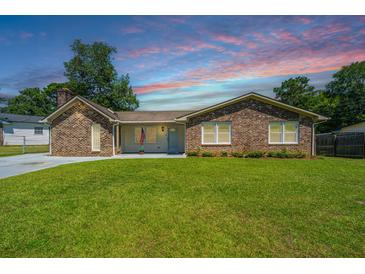 Charming brick home featuring a large front yard and traditional architectural details at 127 Rahway Rd, Goose Creek, SC 29445