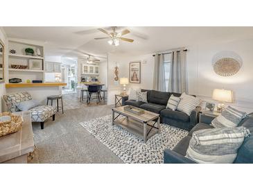 Cozy living room with plush seating, stylish decor, and an open layout to the dining area at 1617 Refuge Run, Charleston, SC 29412
