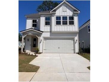 Charming two-story home with white siding, a covered porch, and a spacious two-car garage at 1716 Grovehurst Dr, Charleston, SC 29414